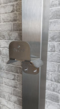 EV charger cable management bracket stainless steel side view installed against brick wall