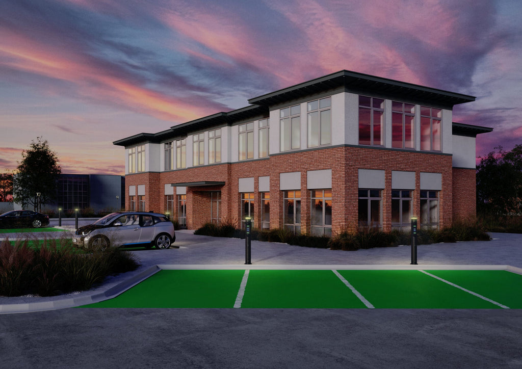 Ratio iO7 bollard EV chargers installed at dusk outside modern office building with green-painted EV parking bays and BMW i3 plugged in