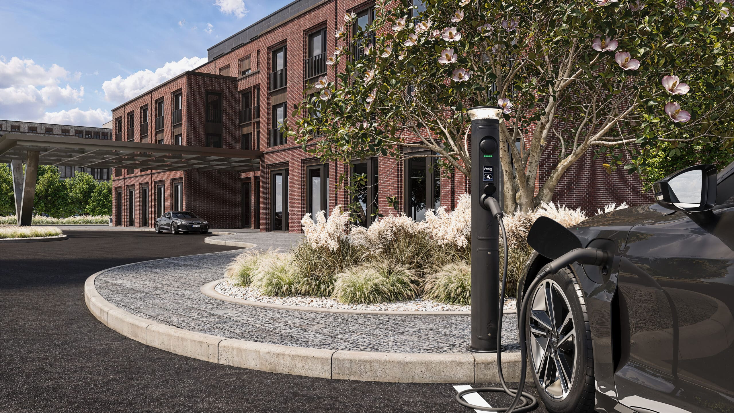 Ratio iO8 bollard EV charger installed at modern apartment block with magnolia tree, Type 2 cable connected to dark Audi-style EV