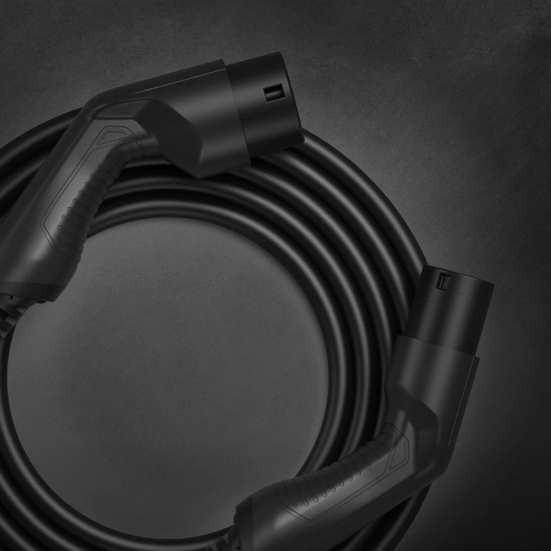 Type 2 to Type 2 EV charging cable coiled in black with male and female Mennekes connectors on dark grey background