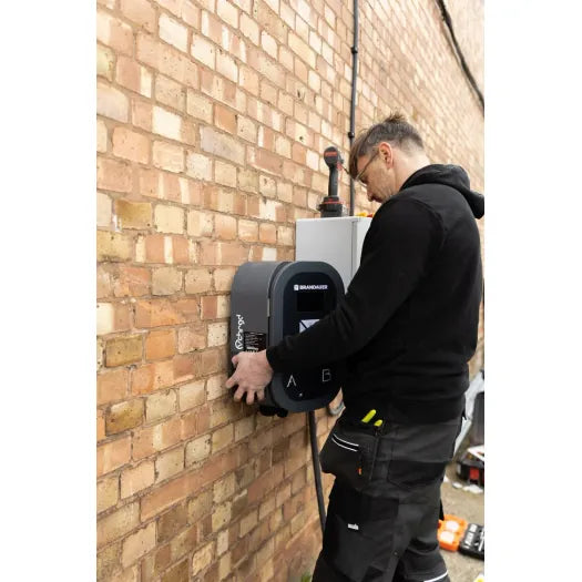 vCHRGD dual EV charger professionally installed on brick wall - UK home installation