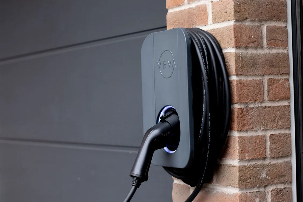 VEVA 7.4kW tethered EV charger in grey, wall-mounted on brick - buy UK home EV charging point