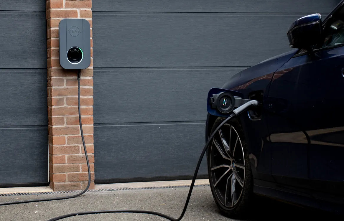 VEVA 7.4kW EV charger mounted on brick pillar charging a car - UK home charging point