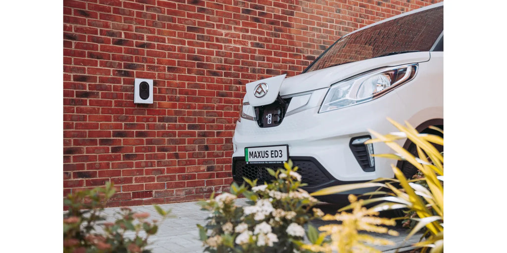 Zaptec Go EV Charger in White Wall-Mounted Next to Electric Vehicle
