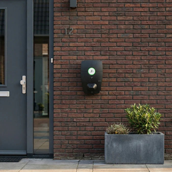 Zaptec Pro 22kW EV charger wall-mounted on brick house exterior - buy V2G bi-directional home charging point